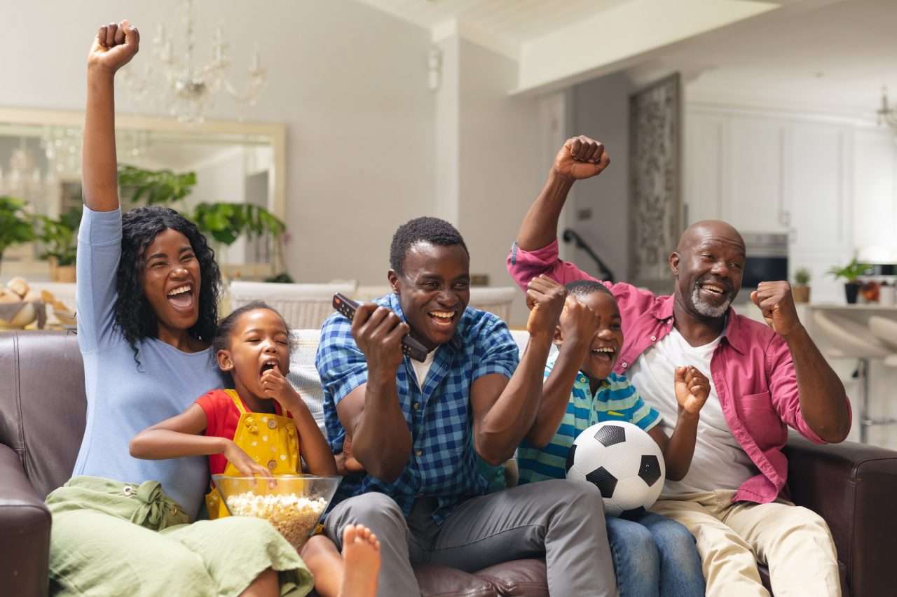 african-american-multi-generational-family-cheering-while-watching-soccer-match-on-tv-at-home.jpg