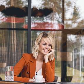 cheerful-blonde-businesswoman-sitting-in-her-offic-2023-11-27-04-50-07-utc-1.jpg
