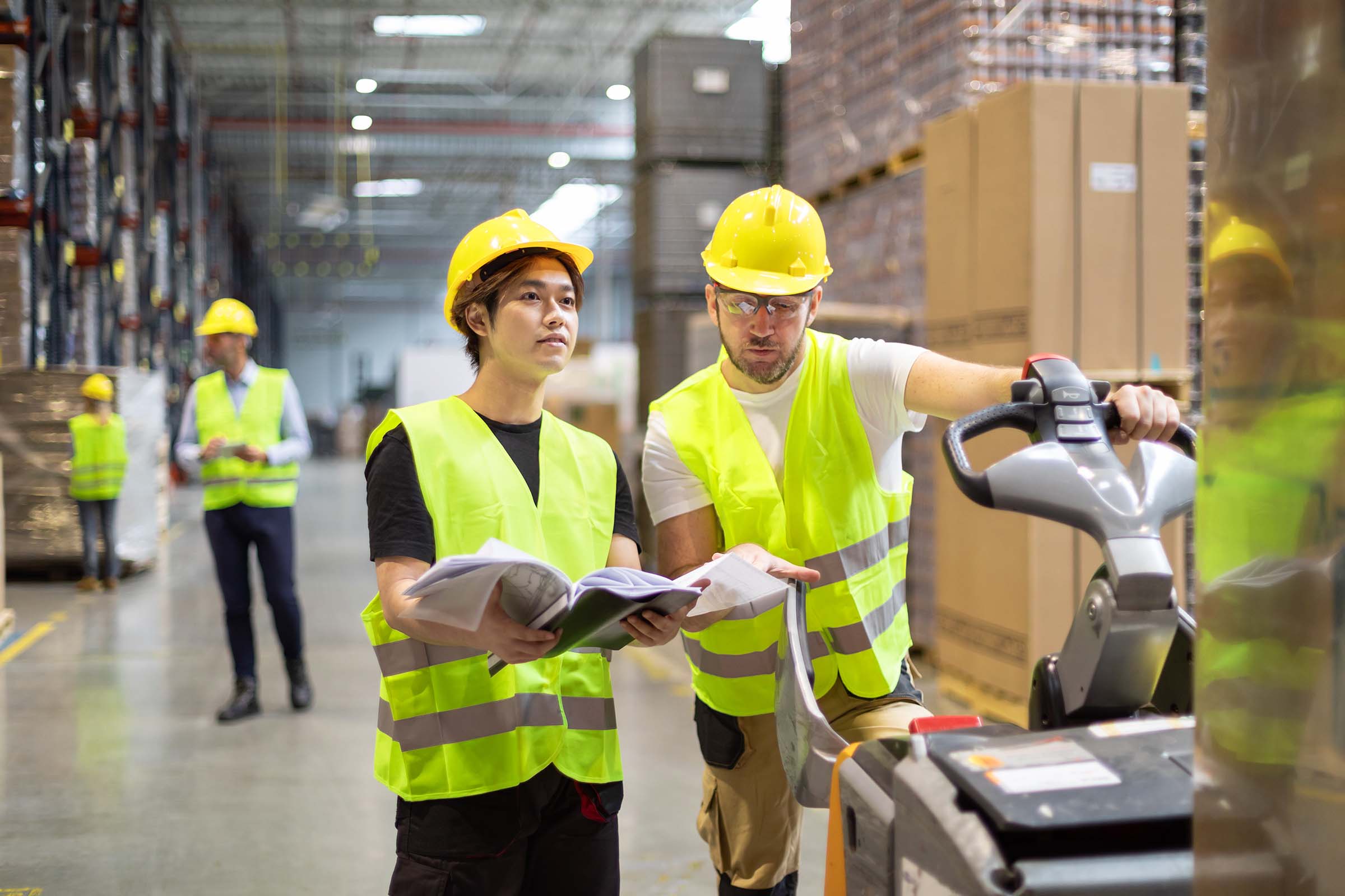 employees-consult-while-working-in-the-warehouse-FFRA3HS.jpg