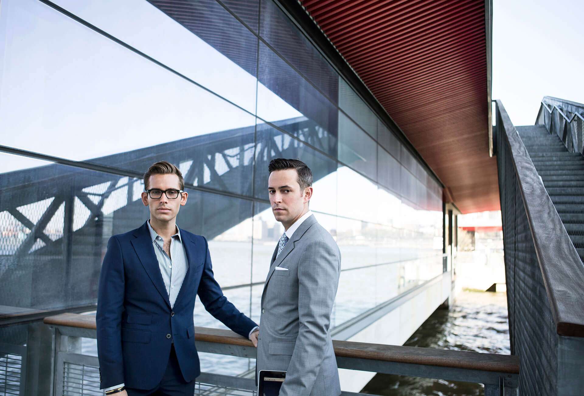 portrait-of-confident-businessmen-standing-against-Z64GL75.jpg