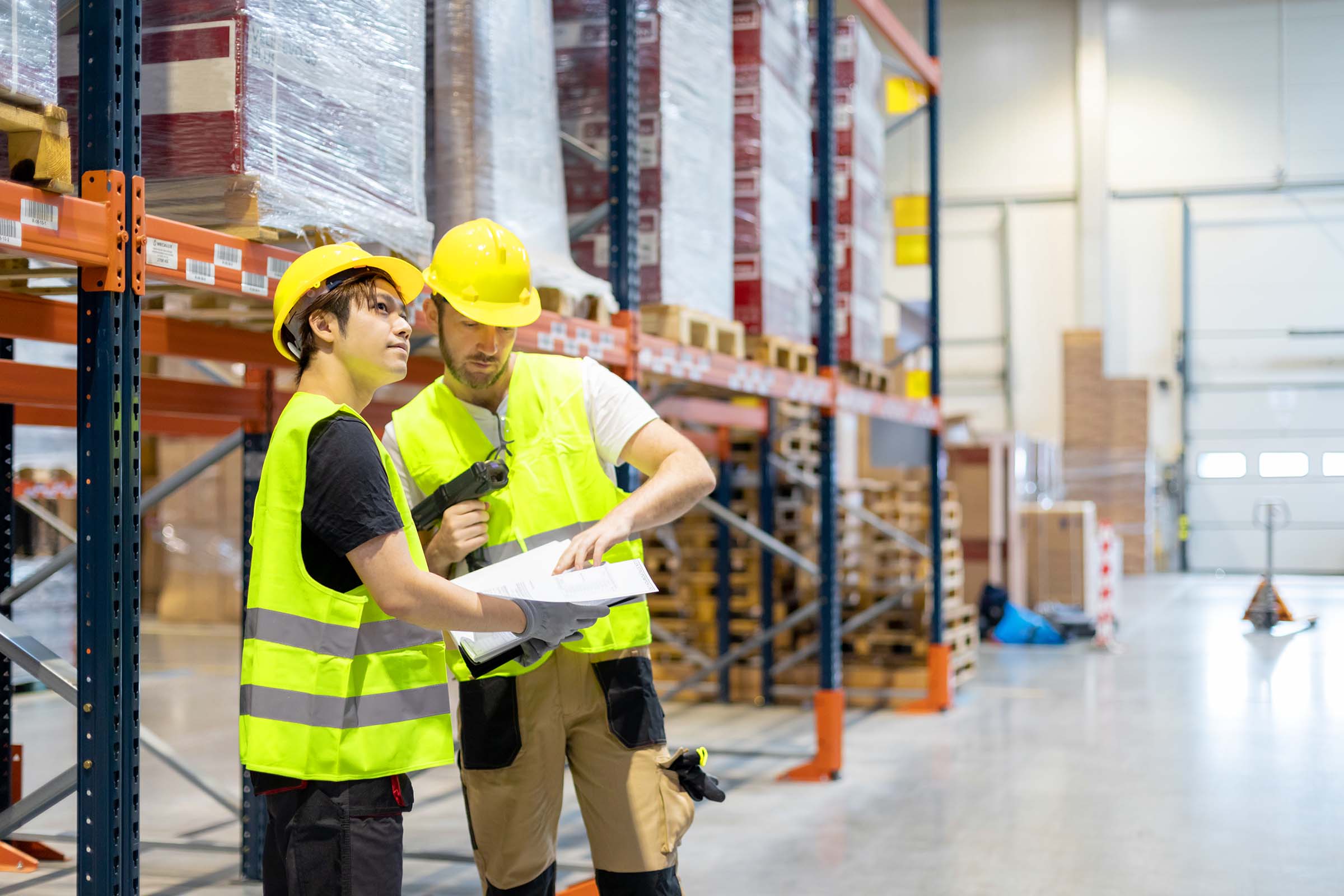 warehouse-workers-looking-on-documents-and-checkin-YWFQ59D.jpg