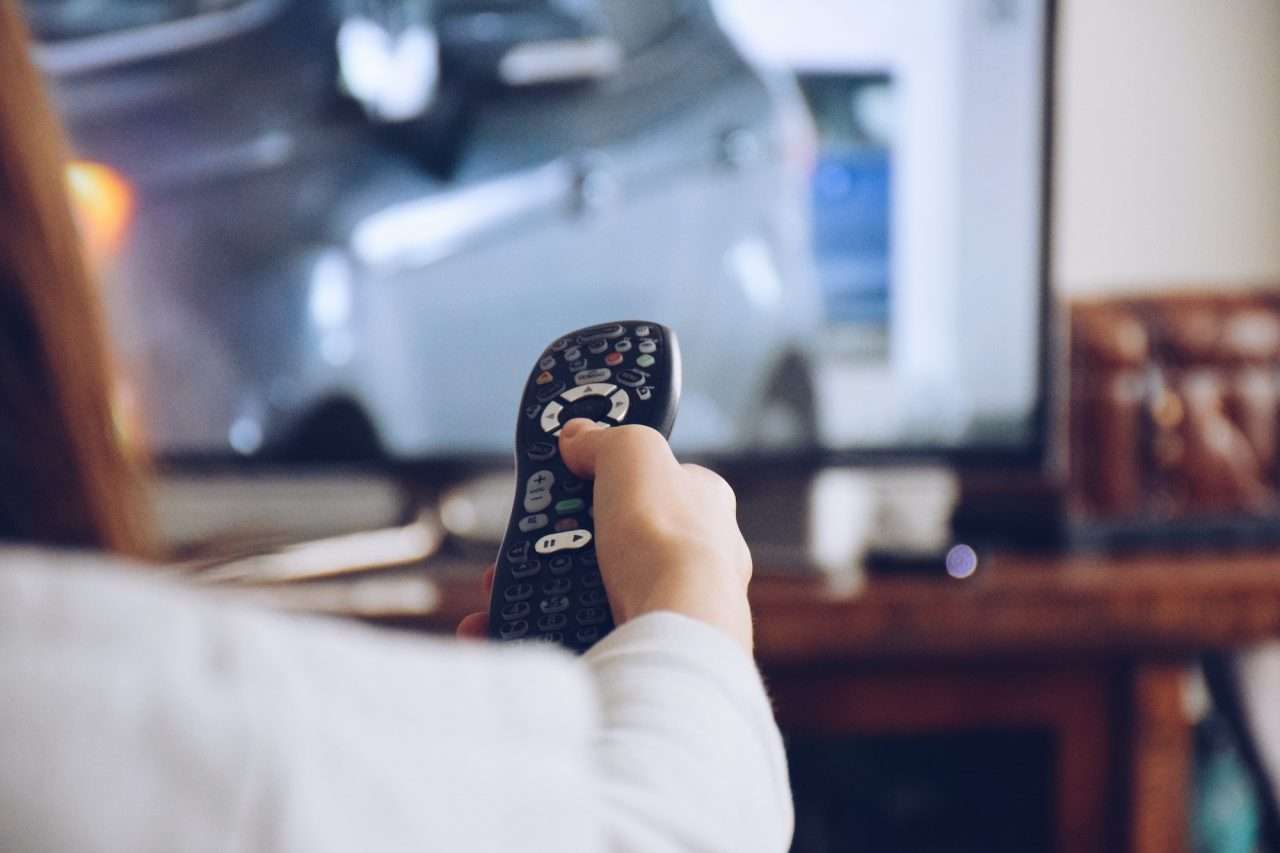 young-girl-holding-a-remote-to-flip-channels-on-a-tv.jpg