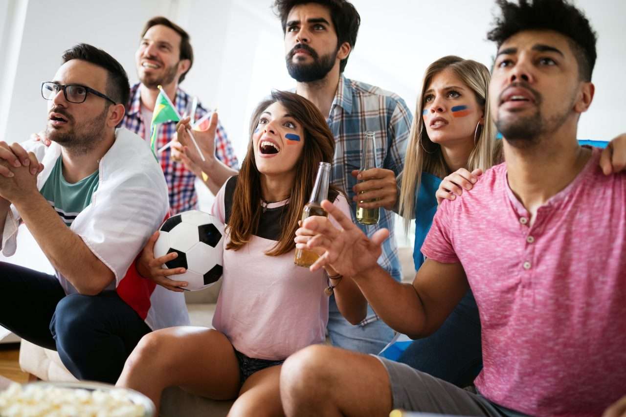young-group-of-friends-watching-sport-on-television.jpg